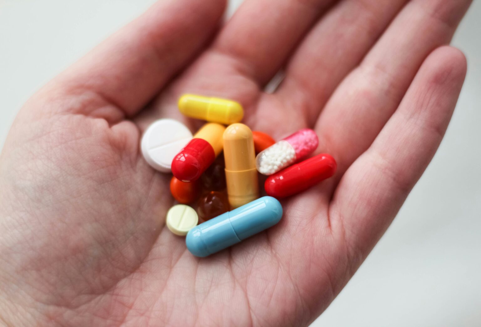Various pills held in hand Various pills held in hand