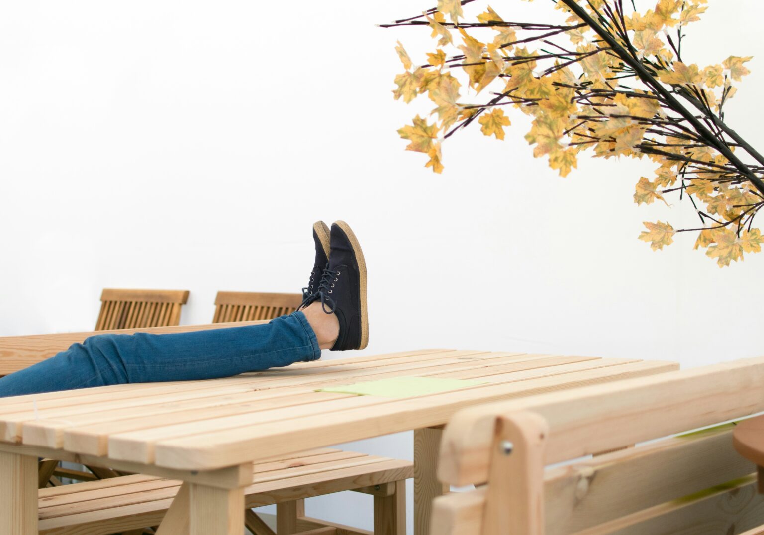 A person holding their legs on a table